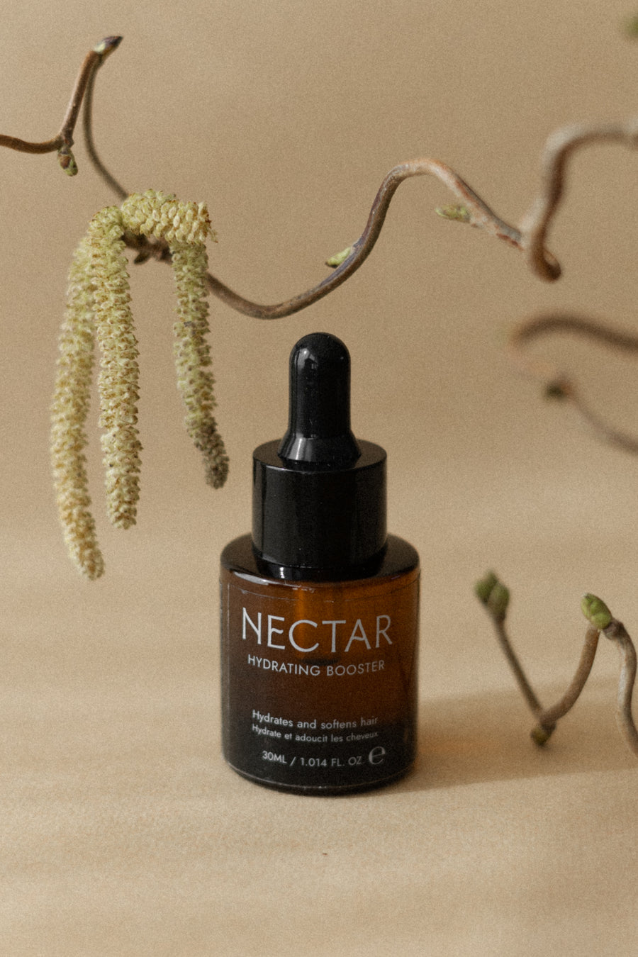 Botanical oil ingredients used in Archetype's Nectar Hydrating
Booster, shown near curly hair roots